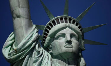 A tourist's hand is seen at the crown of the Statue of Liberty in February 2019 in New York City. The public can once again enter the crown portion of the Statue of Liberty -- the first time since it closed its doors in March 2020.