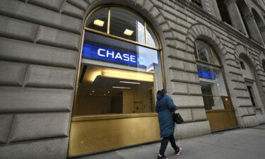 JPMorgan Chase has started offering customers early access to their direct deposits this week. A woman here walks past a JPMorgan Chase bank branch in New York