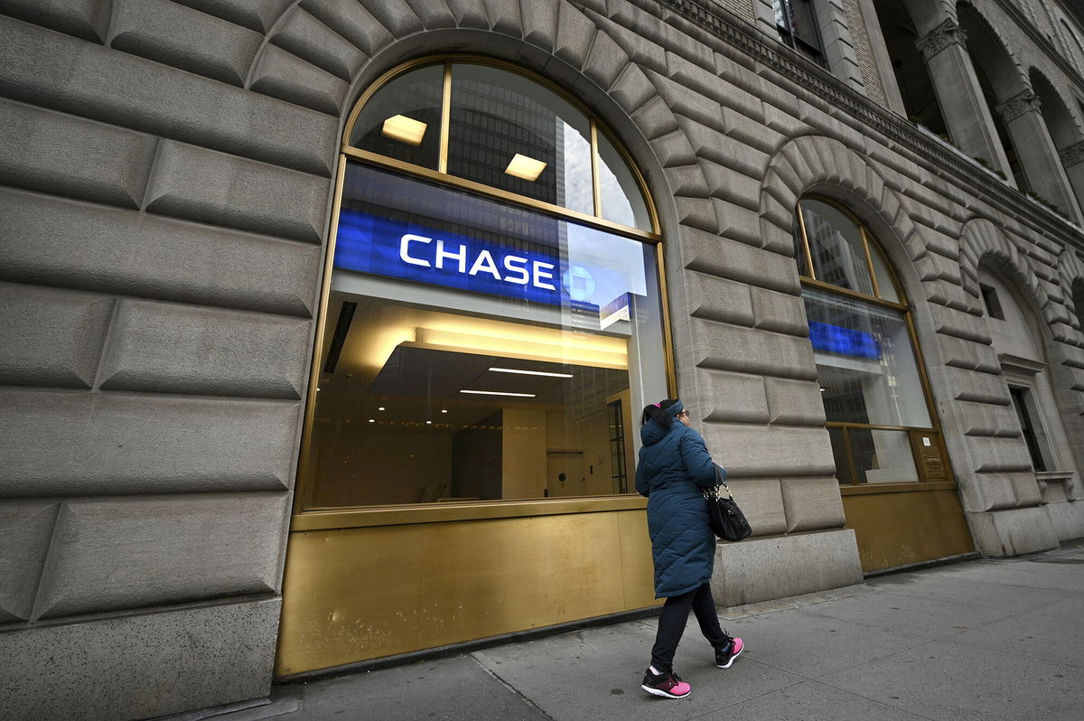 <i>Anthony Behar/Sipa USA/AP</i><br/>JPMorgan Chase has started offering customers early access to their direct deposits this week. A woman here walks past a JPMorgan Chase bank branch in New York