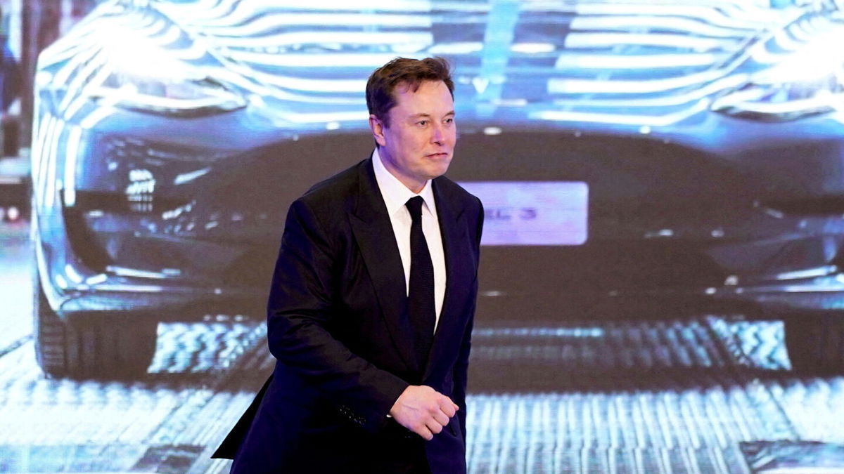 <i>Aly Song/Reuters</i><br/>Tesla Inc CEO Elon Musk walks next to a screen showing an image of Tesla Model 3 car during an opening ceremony for Tesla China-made Model Y program in Shanghai