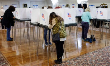 Voters fill out and cast their ballots at an early voting location in Sandy Spring