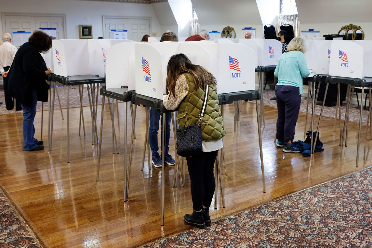 <i>Chip Somodevilla/Getty Images</i><br/>Voters fill out and cast their ballots at an early voting location in Sandy Spring