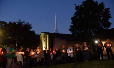 Mourners gather at Beacon Baptist Church for a vigil after five people were gunned down in Raleigh