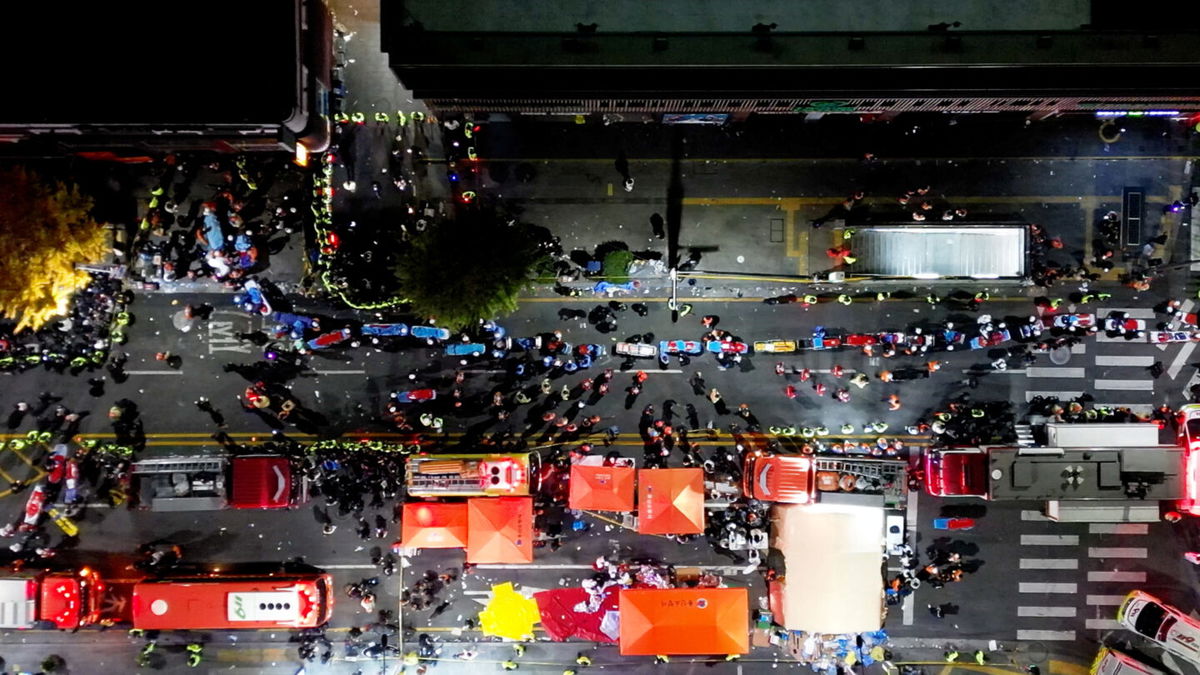 <i>Yonhap News/Reuters</i><br/>Rescue workers work at the scene where a stampede during Halloween festivities killed and injured many people at the popular Itaewon district in Seoul