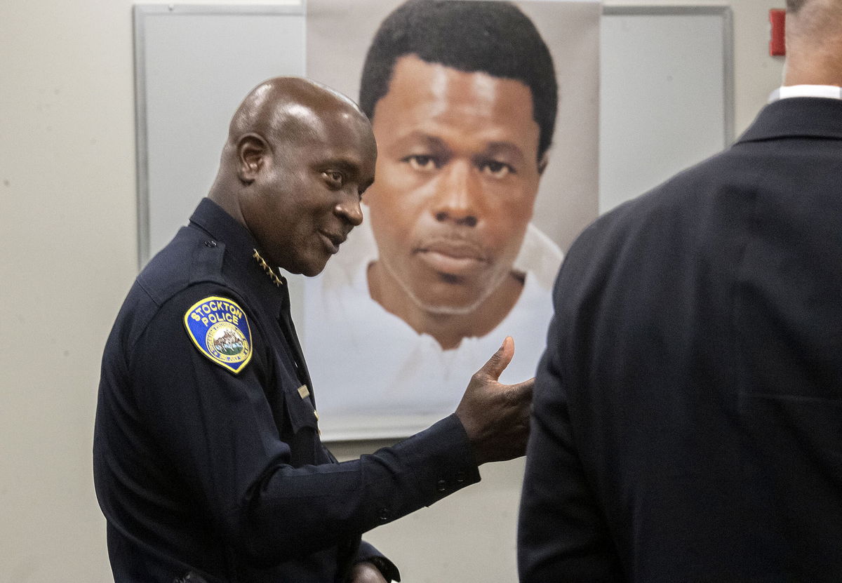 Stockton Police Chief Stanley McFadden speaks during a press conference at the Stockton Police Department headquarters in Stockton, Calif., on the arrest of suspect Wesley Brownlee in the Stockton serial killings on Saturday, Oct. 15, 2022. Behind McFadden is a booking photo of Brownlee. (Clifford Oto/The Record via AP)