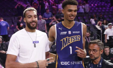 Rudy Gobert (L) poses next to Victor Wembanyama after an exhibition game on October 6.