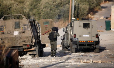 Palestinian youths and Israeli forces clash as troops surround a building in the village of Deir al-Hatab. A Palestinian man was killed and two journalists shot and injured by Israeli forces during an Israeli military raid on October 5.