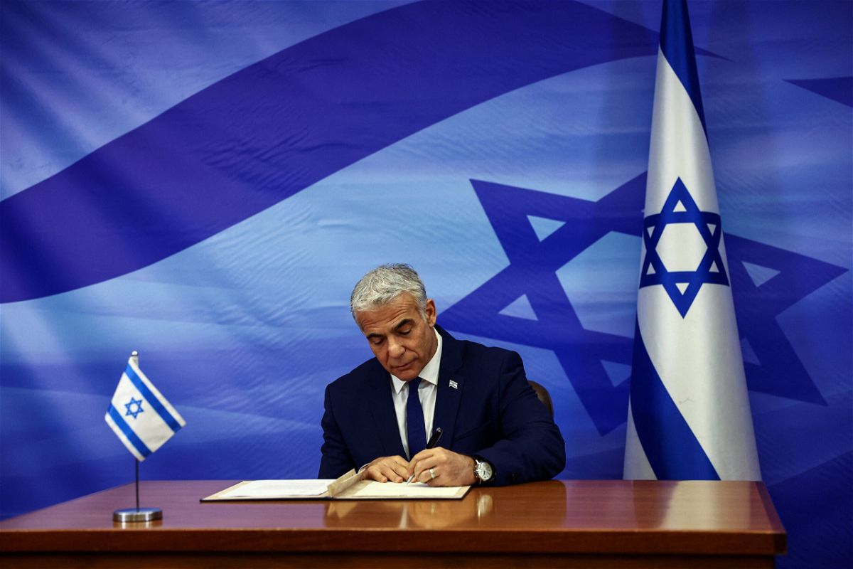 <i>Ronen Zvulun/Reuters</i><br/>Israeli leader Yair Lapid signs the deal setting a maritime border between Israel and Lebanon