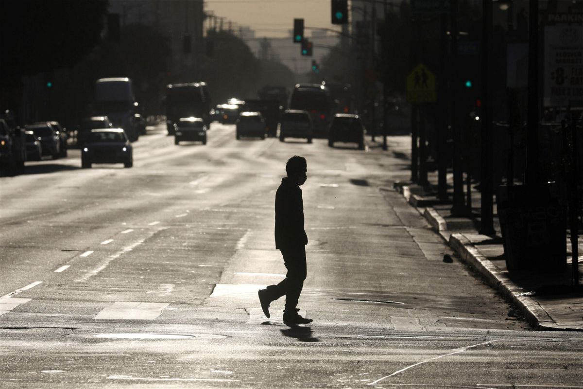 <i>David Swanson/Bloomberg/Getty Images</i><br/>A pedestrian crosses a street in downtown Los Angeles on Dec. 3