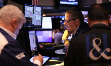 Traders work on the floor of the New York Stock exchange during morning trading on October 18