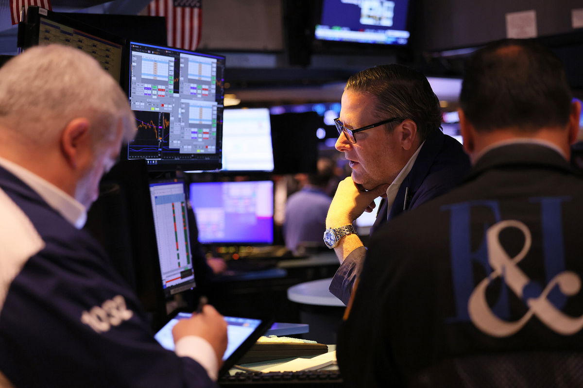 <i>Michael M. Santiago/Getty Images</i><br/>Traders work on the floor of the New York Stock exchange during morning trading on October 18