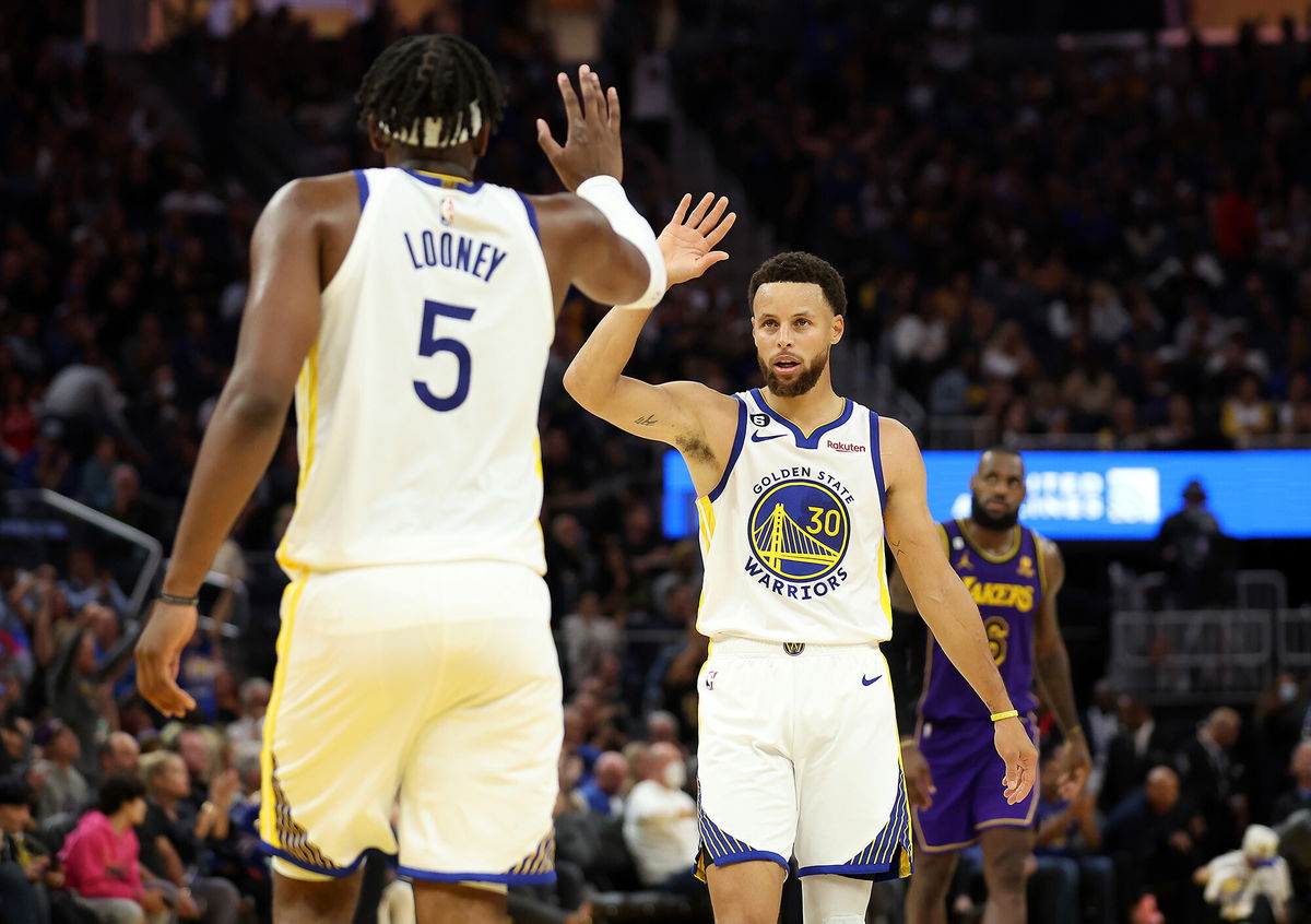 <i>Ezra Shaw/Getty Images</i><br/>Curry high-fives Kevon Looney during the third quarter of the game against Lakers on Tuesday.