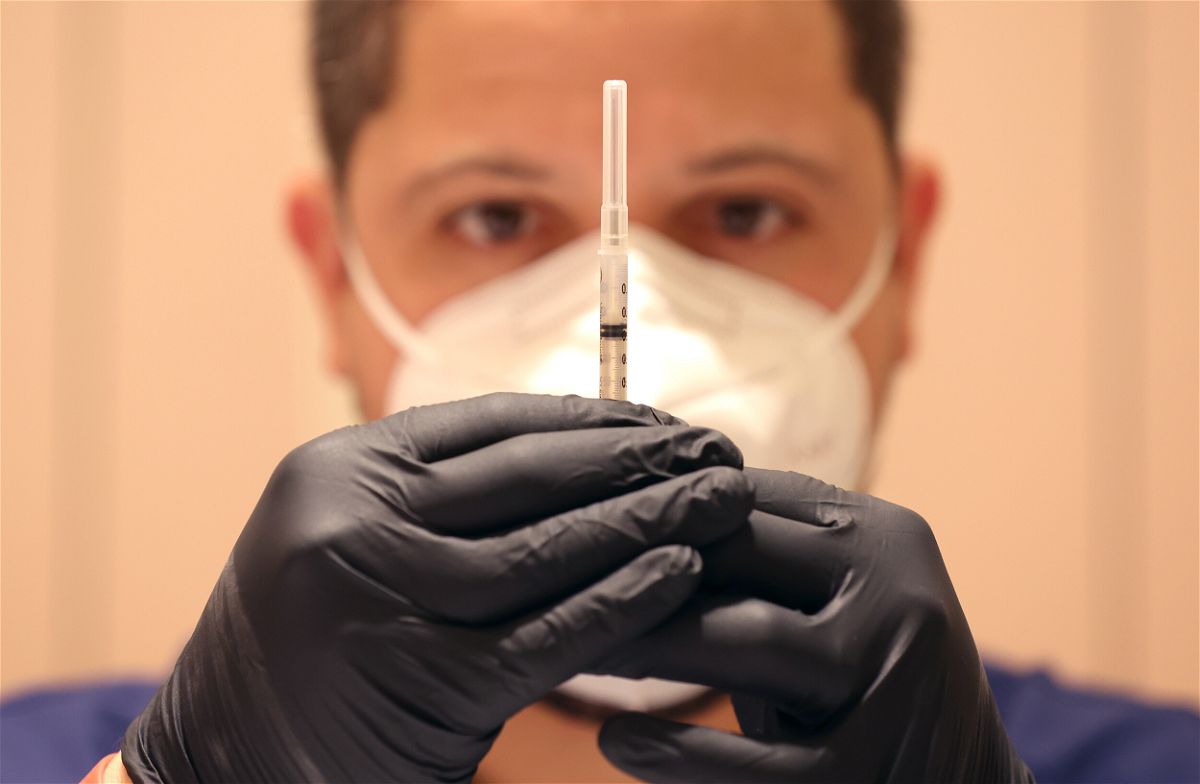 <i>Justin Sullivan/Getty Images/FILE</i><br/>Jatniel Hernandez fills syringes with COID-19 vaccine booster shots on April 6 in San Rafael