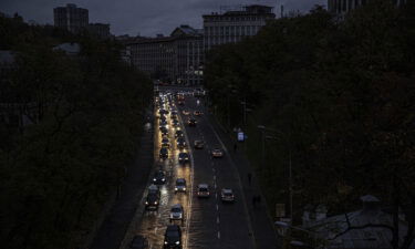 The bright headlights of cars light a darken road in Kyiv on October 20.