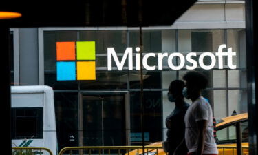 Pedestrians walk past a Microsoft Technology Center in New York in July 2020. Microsoft posted a double-digit profit decline in the three-month period ending in September.