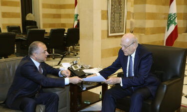 Lebanese Prime Minister Najib Makati (R) receives the final draft of the maritime border agreement between Lebanon and Israel from his deputy Elias Bou Saab (L) who leads the Lebanese negotiating team