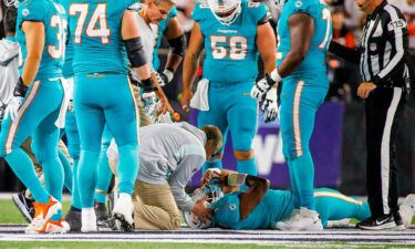 Miami Dolphins quarterback Tua Tagovailoa (1) is attended by medical staff after being sacked on September 29 in Cincinnati