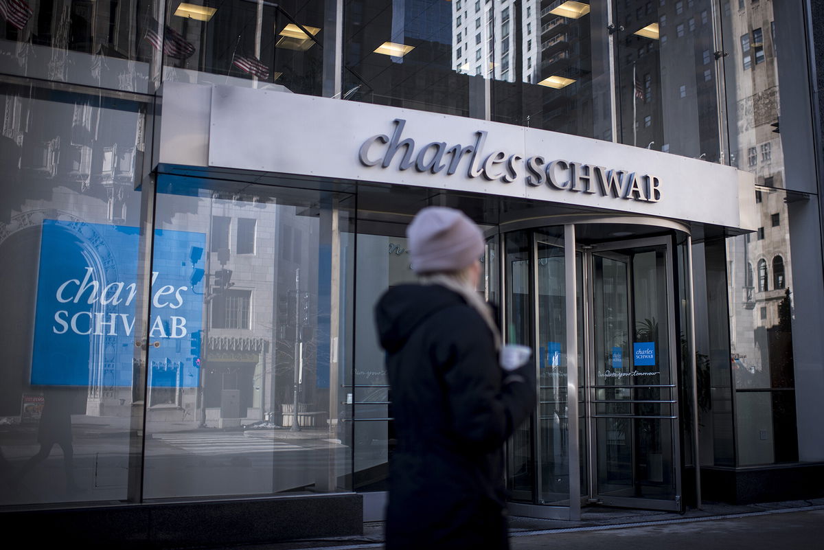 <i>Christopher Dilts/Bloomberg/Getty Images</i><br/>A pedestrian passes in front of a Charles Schwab Corp. bank branch in downtown Chicago