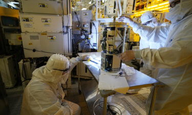 Technicians inspect a piece of equipment during a tour of the Micron Technology automotive chip manufacturing plant February 11