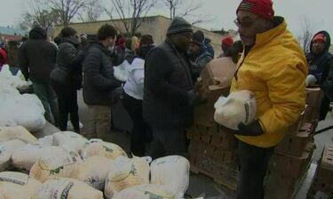 Volunteers from Beta Delta Phi sorority and Beta Alpha Delta fraternity were covered in snow and working in collaboration with Servants for Hope to pass out 800 turkey and ham meal kits.