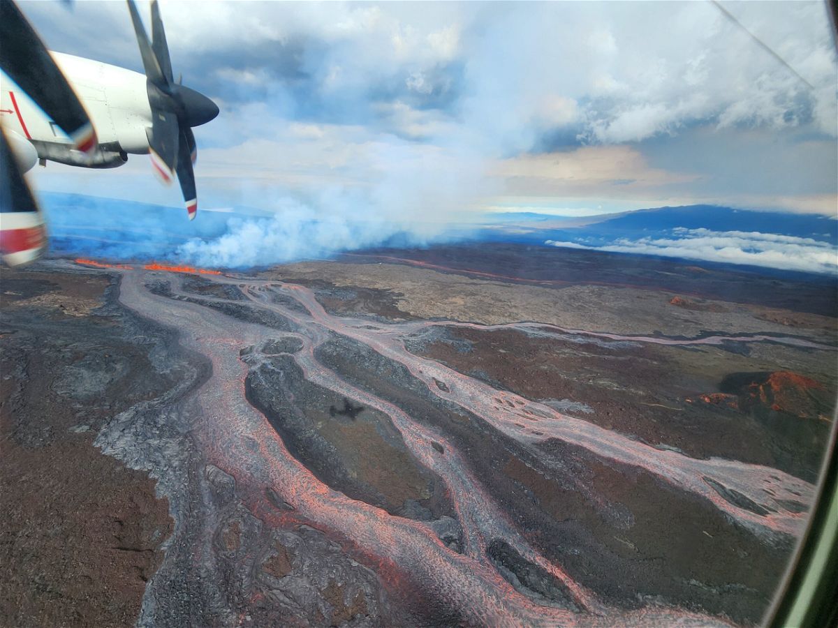 <i>United States Geological Survey</i><br/>Aerial photo of a fissure and lava flows on Mauna Loa's Northeast Rift Zone at approximately 9:30 a.m. HST on November 28. The photo view is to the NW