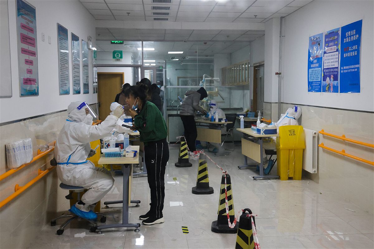 <i>Lintao Zhang/Getty Images</i><br/>China reports first Covid-19 deaths in nearly 6 months as cases spike. Pictured is a Covid-19 test center  on November 20