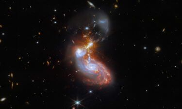 A merging galaxy pair cavort in this image captured by the James Webb Space Telescope. This pair of galaxies