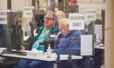 Tabulators work to process ballots at the Maricopa County Tabulation and Election Center in Phoenix