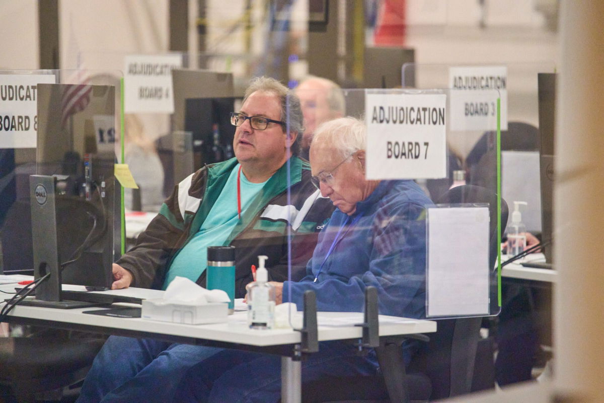 <i>Alex Gould/The Republic/USA Today Network</i><br/>Tabulators work to process ballots at the Maricopa County Tabulation and Election Center in Phoenix