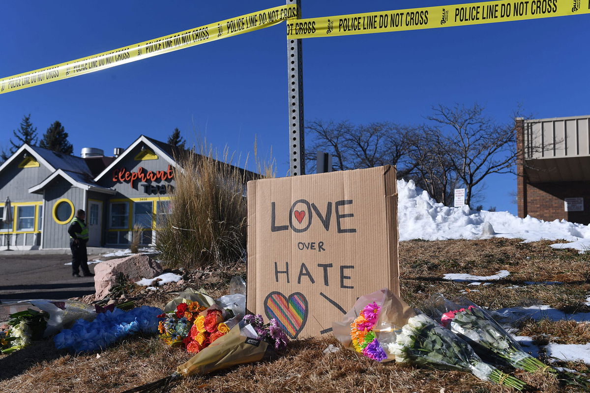 <i>Jason Connolly/AFP/Getty Images</i><br/>Bouquets of flowers and a sign reading 