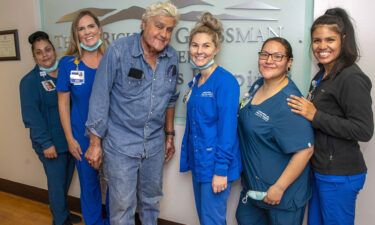 Jay Leno has been discharged from the hospital after sustaining burn injuries in a gasoline fire. Leno is seen here with the staff of the Grossman Burn Center on November 21.