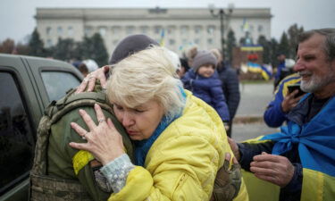 A local hugs a Ukrainian serviceman as people celebrate after Russia's retreat from Kherson city