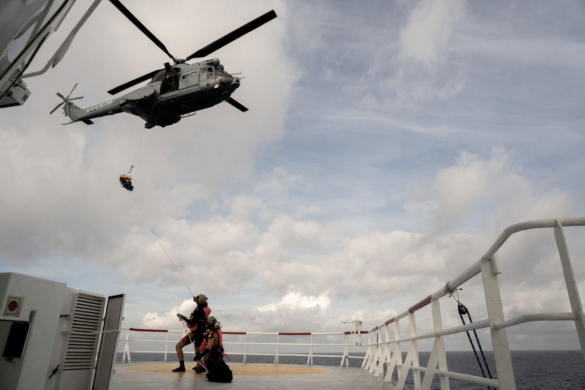 <i>Vincenzo Circosta/AFP/Getty Images</i><br/>A migrant in need of urgent medical care is winched up on a stretcher by a helicopter of the French Army from the Ocean Viking rescue ship on November 10 in the Tyrrhenian Sea between Italy and Corsica island.