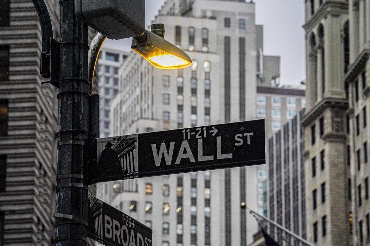 <i>Bebeto Matthews/AP</i><br/>A street light brightens a Wall Street sign outside the New York Stock Exchange