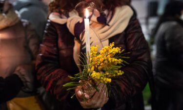 More than 100 women were murdered in Italy so far this year. A woman holds a candle during the torchlight procession against Anna Borsa's femicide on March 1