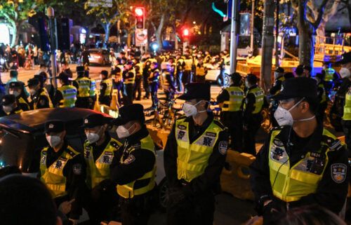 Police officers block Shanghai's Urumqi Road on Sunday.