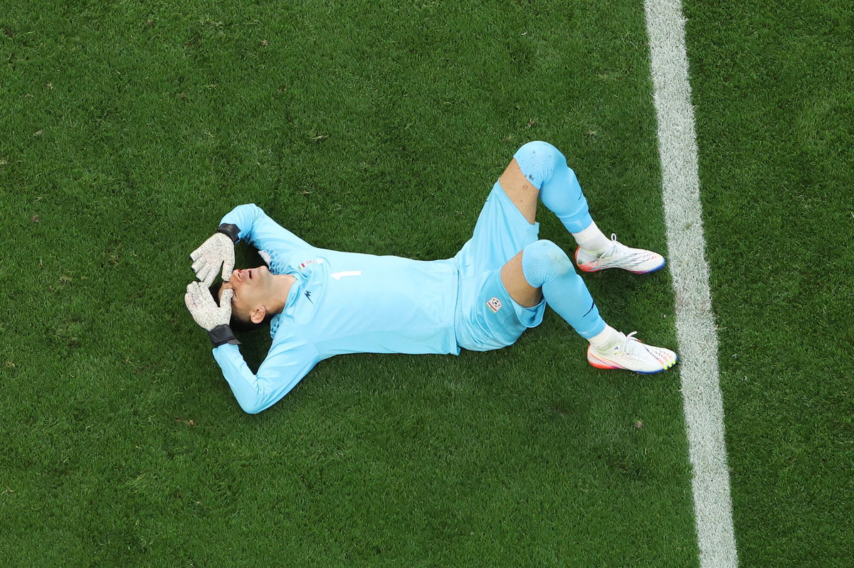 <i>Catherine Ivill/Getty Images</i><br/>Alireza Beiranvand lies injured during Iran's game against England.