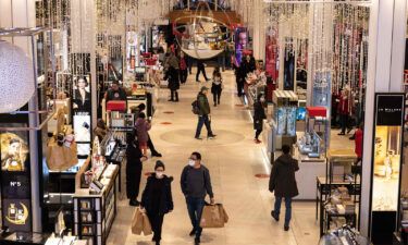 Shoppers walk through Macy's department store in New York City