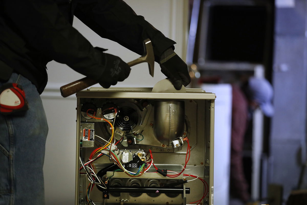 <i>George Frey/Bloomberg/Getty Images</i><br/>A worker prepares to install a new Carrier natural gas furnace at a residential home in Spanish Fork