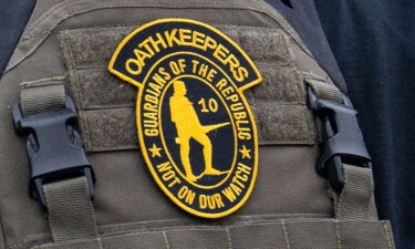 An Oath Keepers member stands guard during a rally in front of the Supreme Court Building on January 5