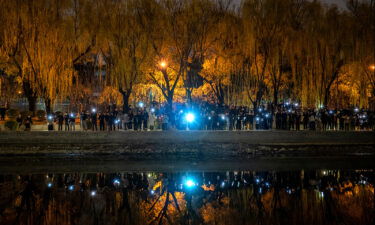 Protesters hold up their mobile phones during a protest against China's strict zero Covid measures on November 27