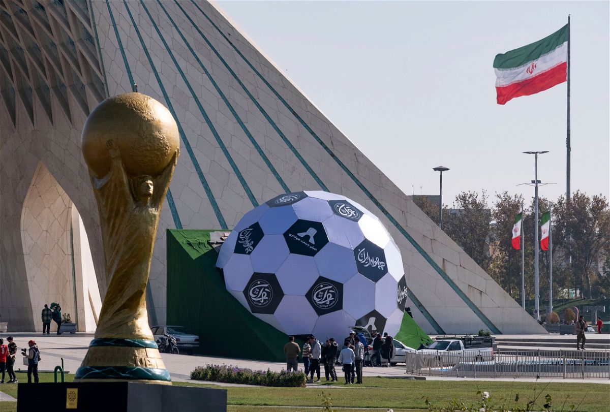 <i>Morteza Nikoubazl/NurPhoto/Getty Images</i><br/>Sculptures of the FIFA World Cup trophy and a soccer ball are seen here in the west of Tehran on November 18. The families of Iran's World Cup soccer team have been threatened if the players fail to 