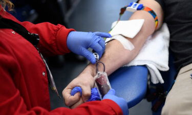 A person donates blood during a Children's Hospital Los Angeles blood donation drive on January 13. The US Food and Drug Administration is considering shifting its blood donation policy away from blanket assessments toward questionnaires that focus more on individual risk.