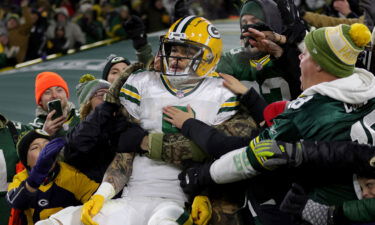 Christian Watson celebrates scoring a touchdown against the Titans at Lambeau Field.