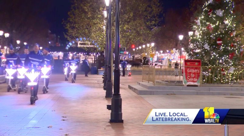 <i>WBAL</i><br/>Some Baltimoreans tried a new way to share the Hanukkah spirit Sunday night as Broadway Square filled up with LED menorahs and life-size dreidels on wheels.