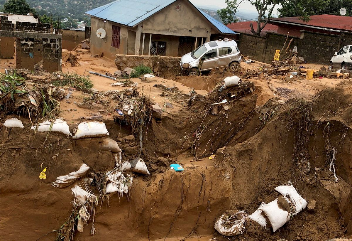 <i>Jude Dibawa/Reuters</i><br/>A car is seen stuck after heavy rains caused floods and landslides