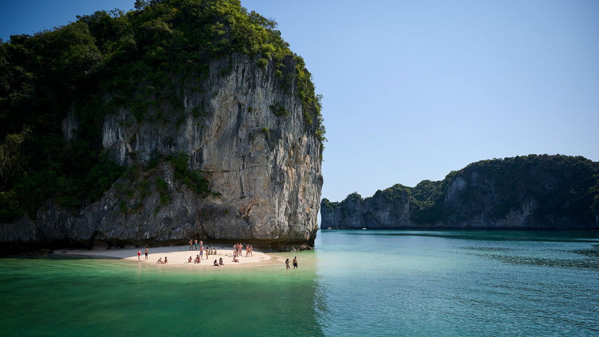 <i>nimnull/iStock Editorial/Getty Images</i><br/>Tourists rest on the beach