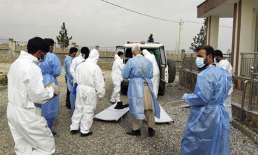 Medical workers collect the bodies of victims of a fuel tanker fire in the Salang Tunnel through the Hindu Kush mountains north of Kabul