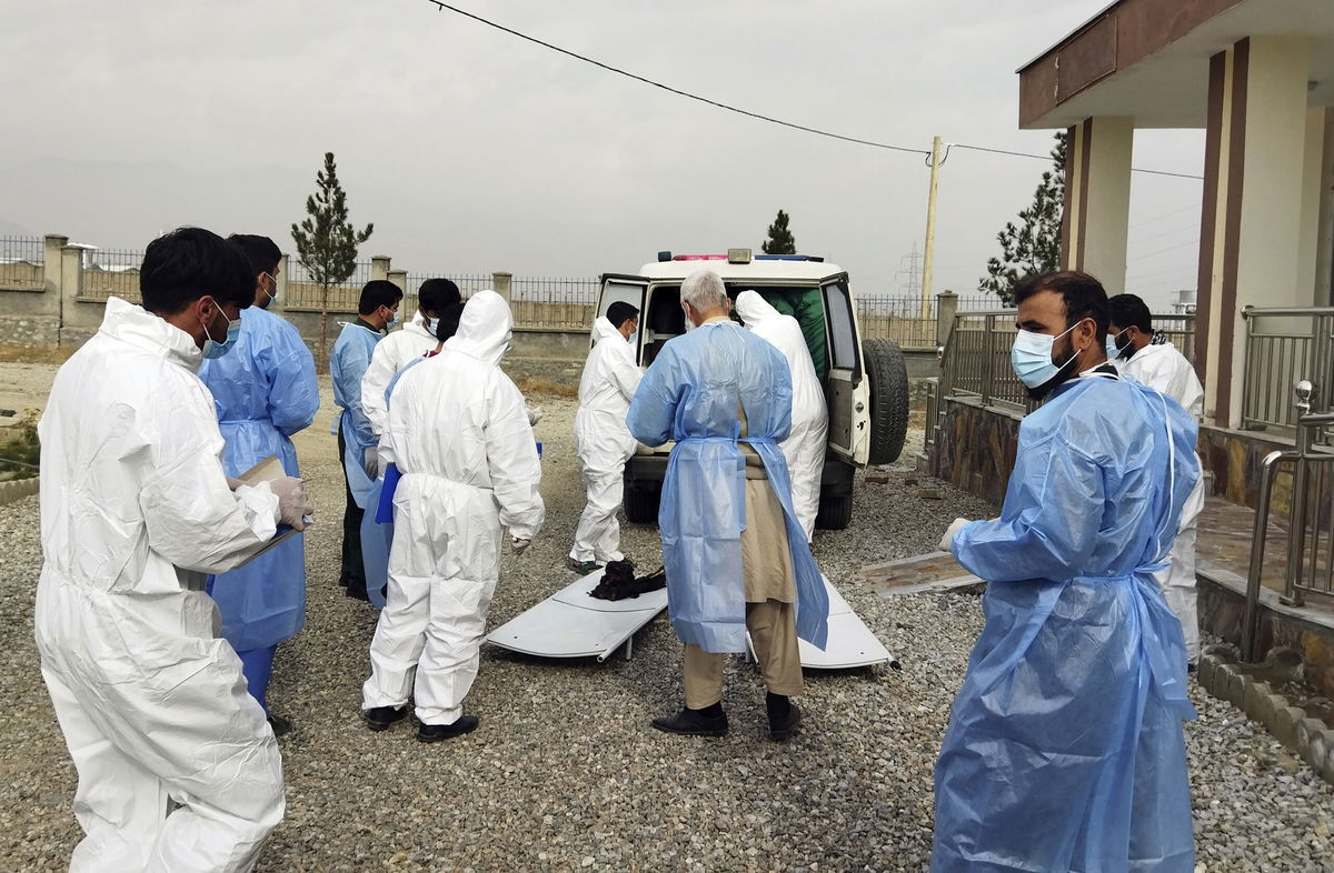 <i>AP</i><br/>Medical workers collect the bodies of victims of a fuel tanker fire in the Salang Tunnel through the Hindu Kush mountains north of Kabul