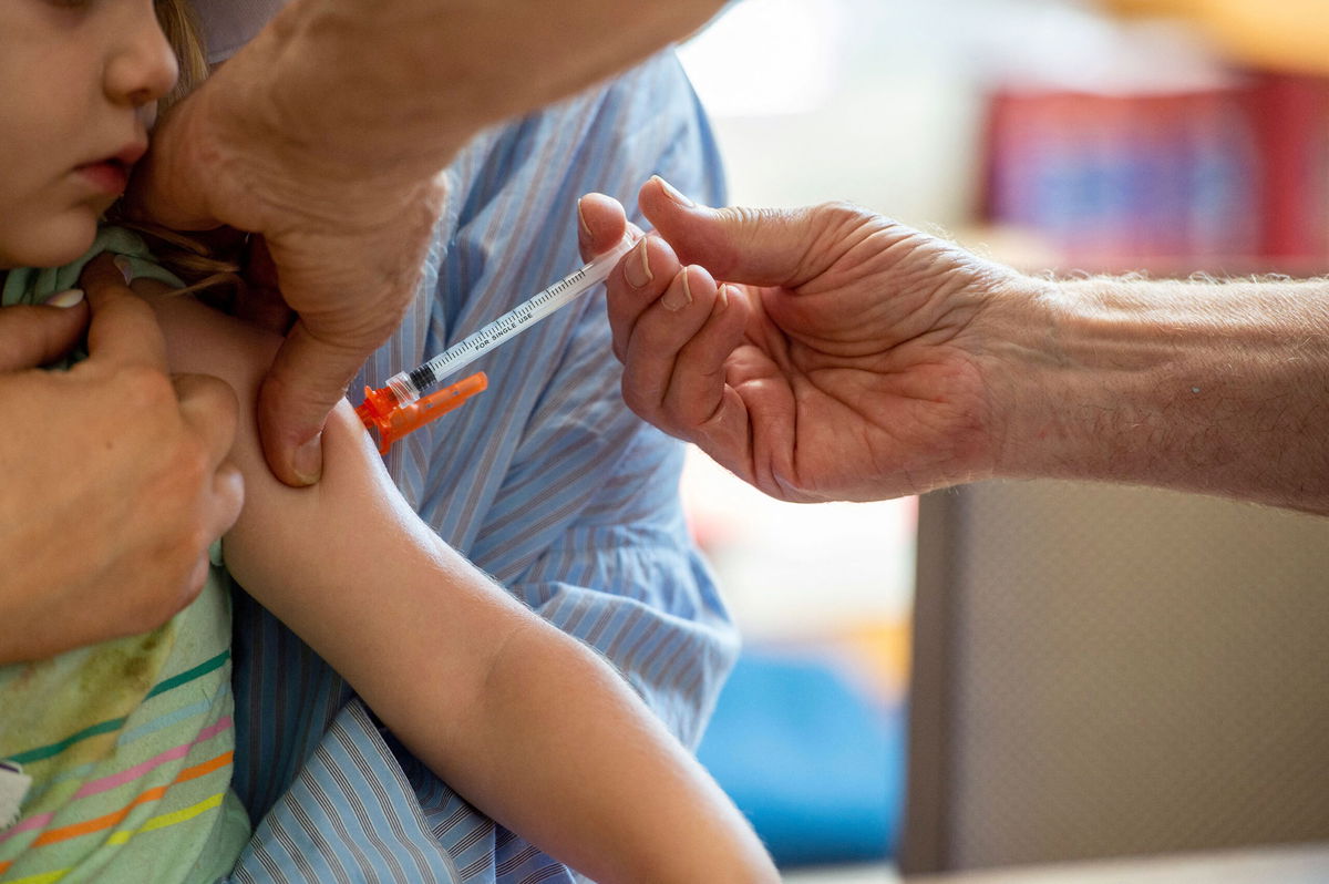 A young child receives a Moderna Covid-19 6 months to 5 years vaccination at Temple Beth Shalom in Needham, Massachusetts on June 21, 2022.
The temple was one of the first sites in the state to offer vaccinations to anyone in the public. - US health authorities on Saturday cleared the Pfizer and Moderna Covid-19 vaccines for children aged five and younger, in a move President Joe Biden greeted as a 